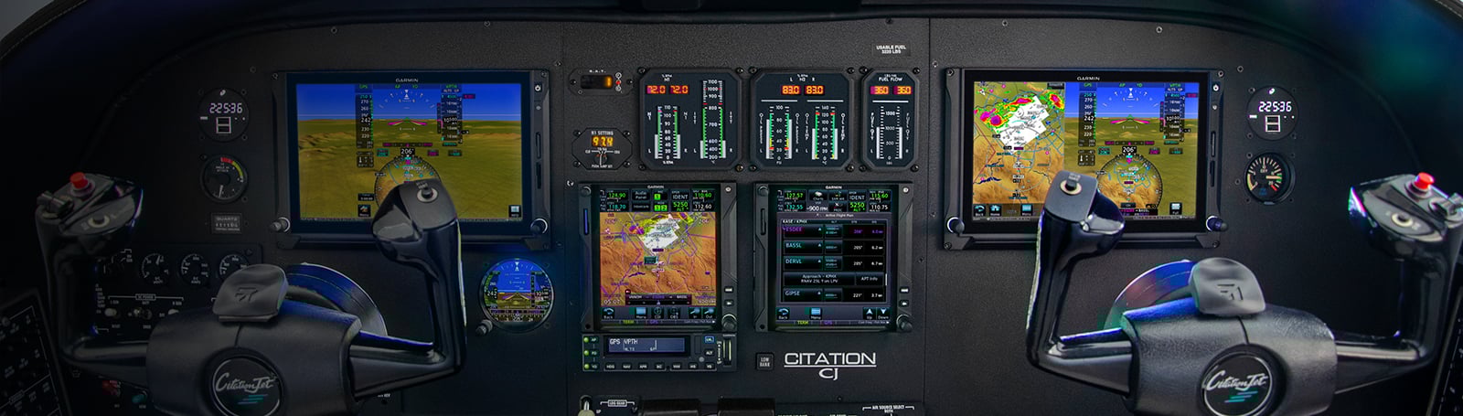 An image showing the dashboard of an airplane showing screen that help the pilot get a electronic understanding of weather hazards in route.
