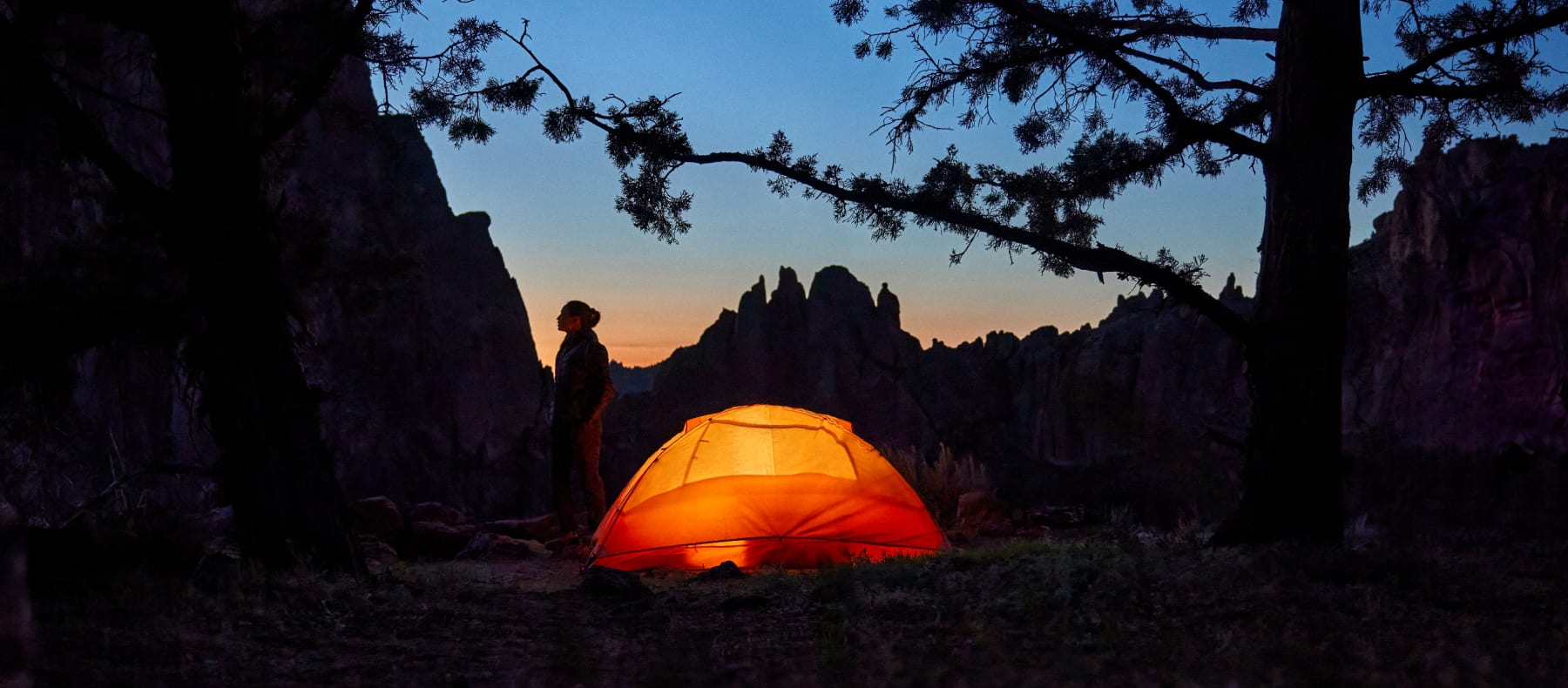Camper with their tent at sunset